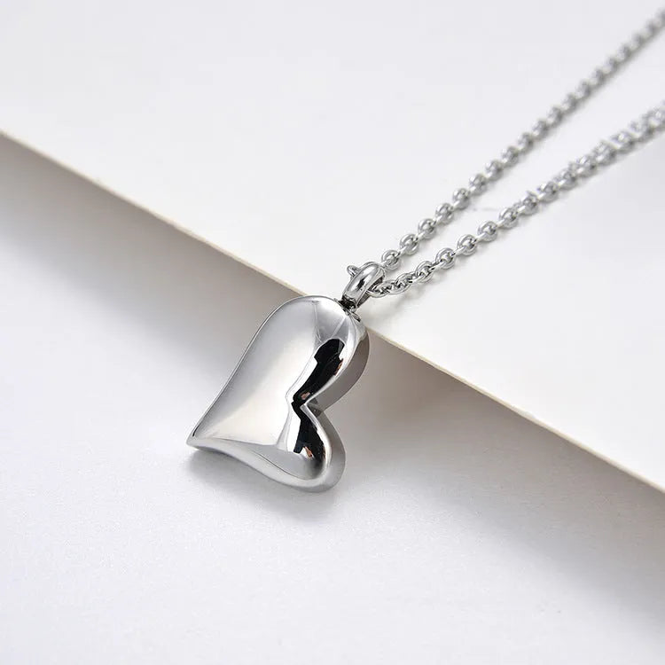 Silver curved peach heart pendant necklace on adjustable stainless steel chain