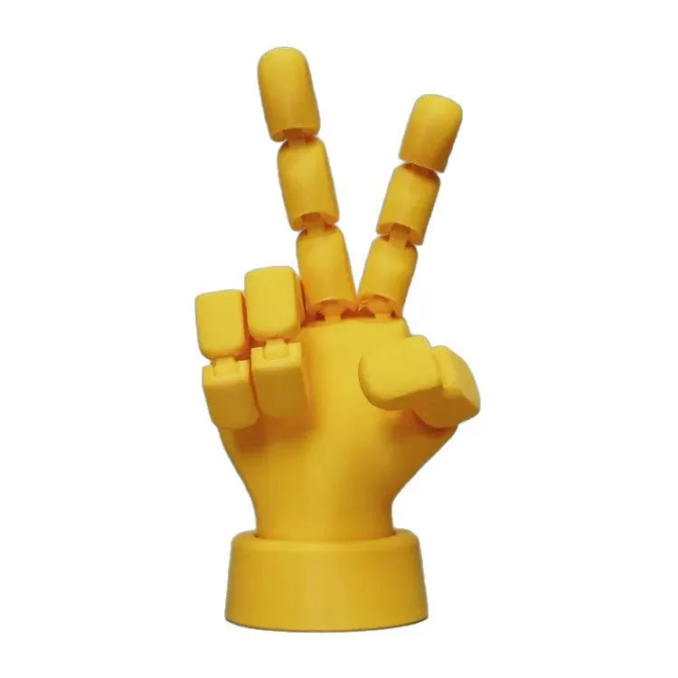 Yellow 3D printed hand ornament with movable joints and detailed sculpting