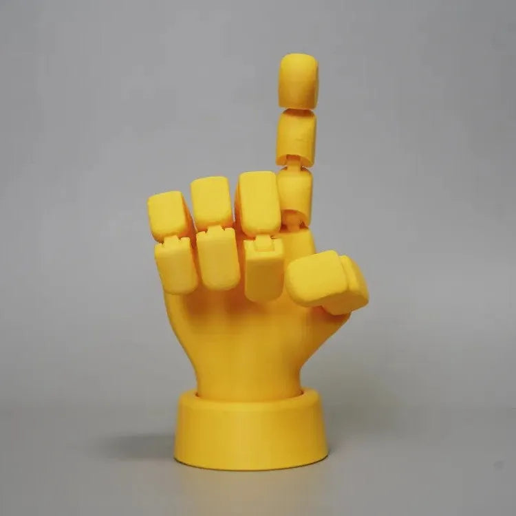 Yellow 3D printed hand ornament with movable joints and detailed sculpting