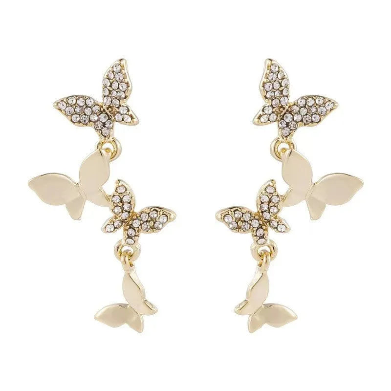 Women's copper butterfly drop earrings with four-element design and gold colour finish