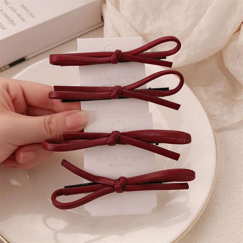 Wine red leather bow hair clip barrette showing advanced bow design and clip mechanism