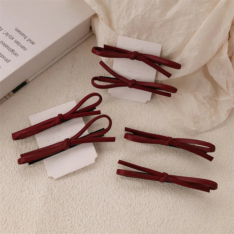 Wine red leather bow hair clip barrette showing advanced bow design and clip mechanism