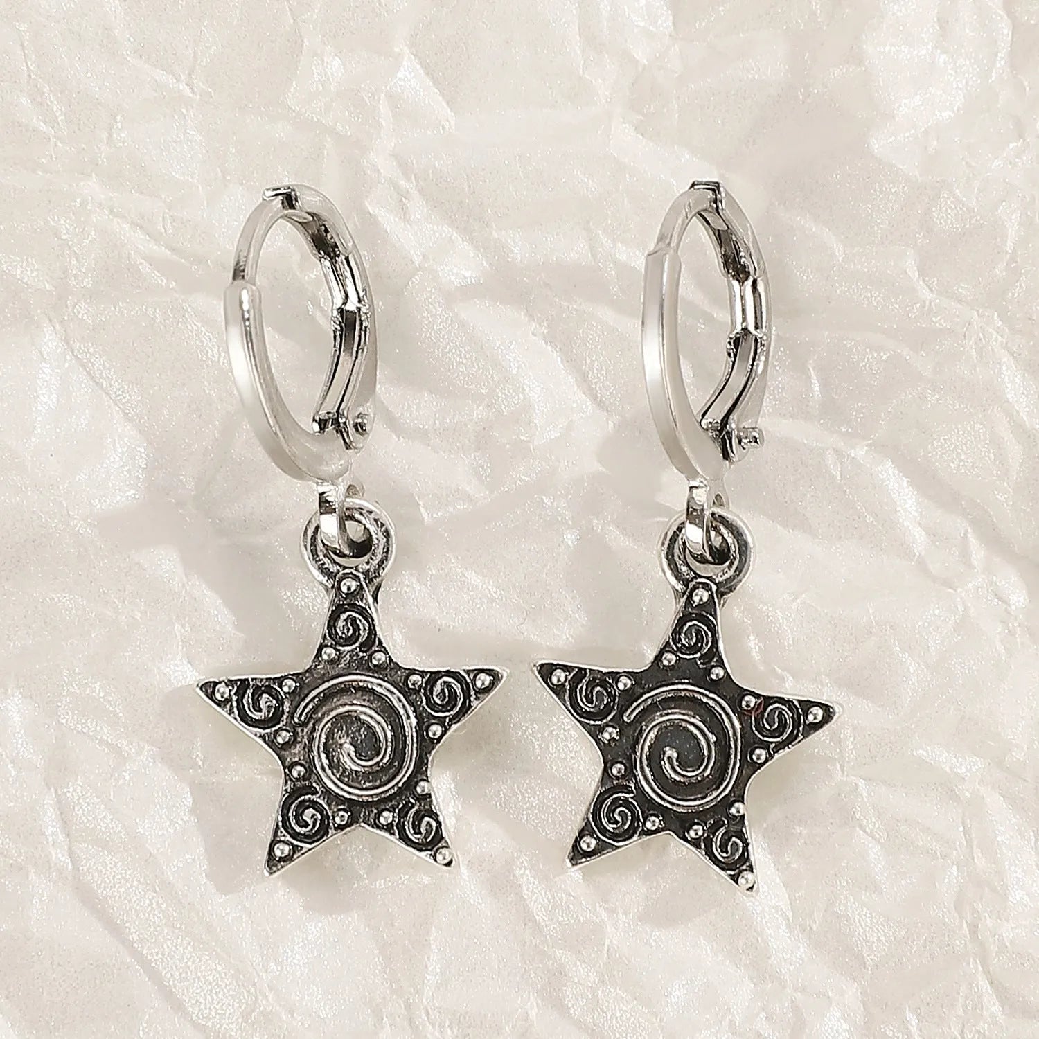 Women's alloy drop earrings featuring cross, heart, and cat charms in white, black, and antique silver finishes.
