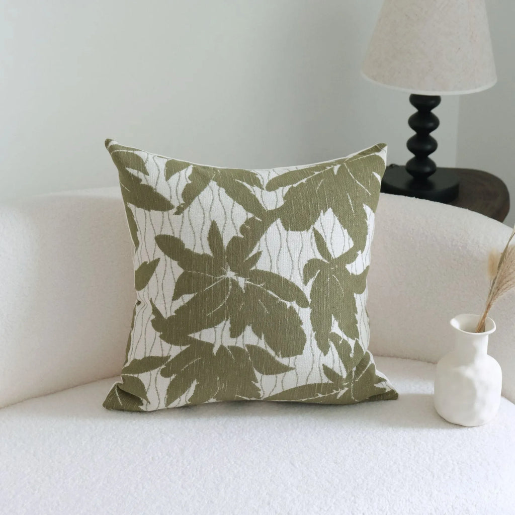 Green cotton and linen tassel hotel sample pillow with botanical patterns on a brushed fabric case