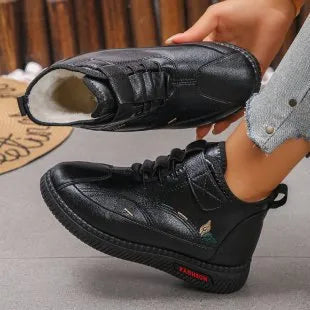 Women's black velvet indoor slip-on shoes with a rubber sole and decorative hollow-out detail