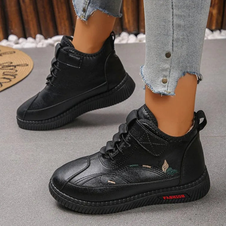 Women's black velvet indoor slip-on shoes with a rubber sole and decorative hollow-out detail