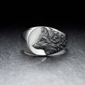 Silver alloy men's ring with a geometric domineering wolf design on a grey background