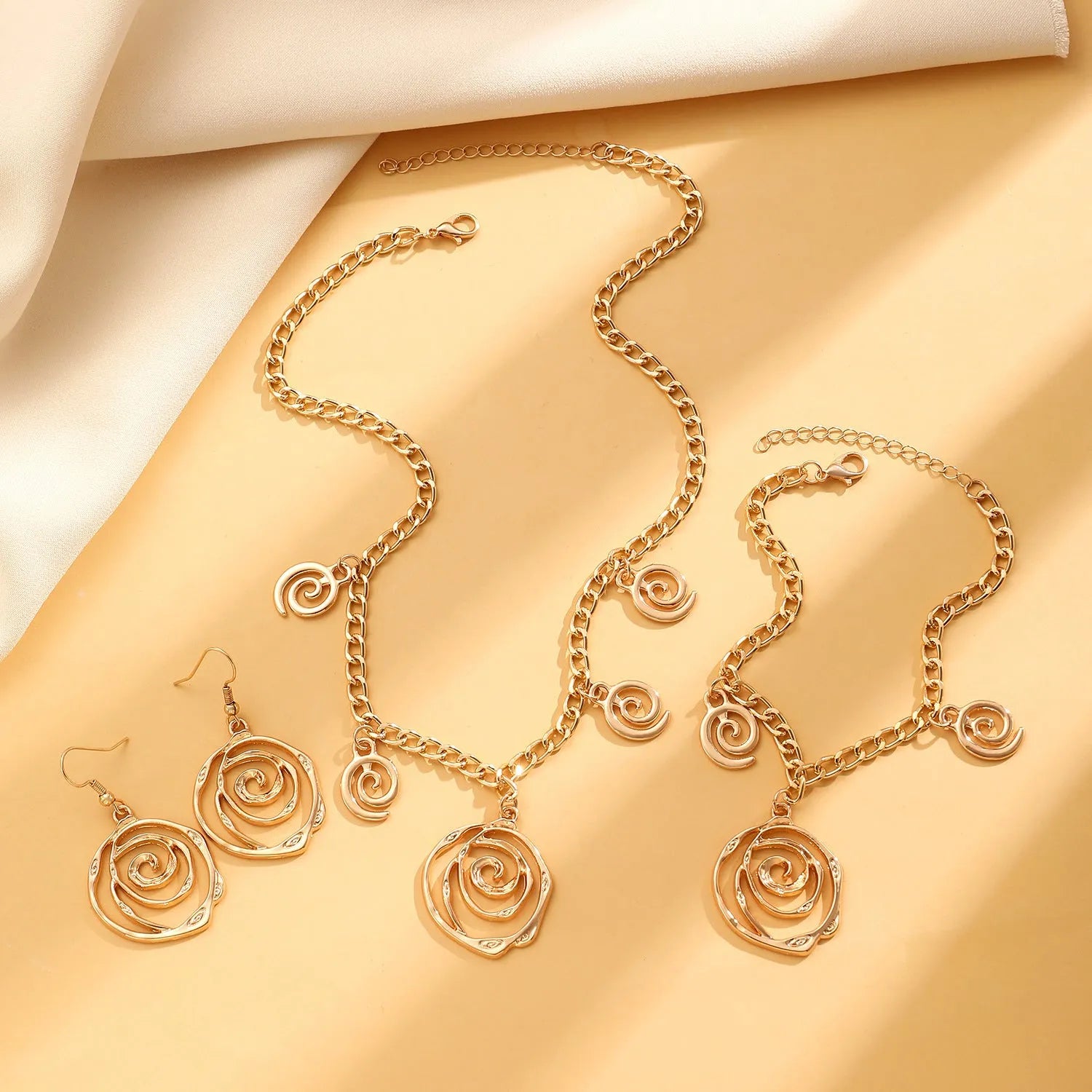 Geometric spiral donut jewellery set with necklace, bracelet, and earrings on adjustable 41-50cm chain