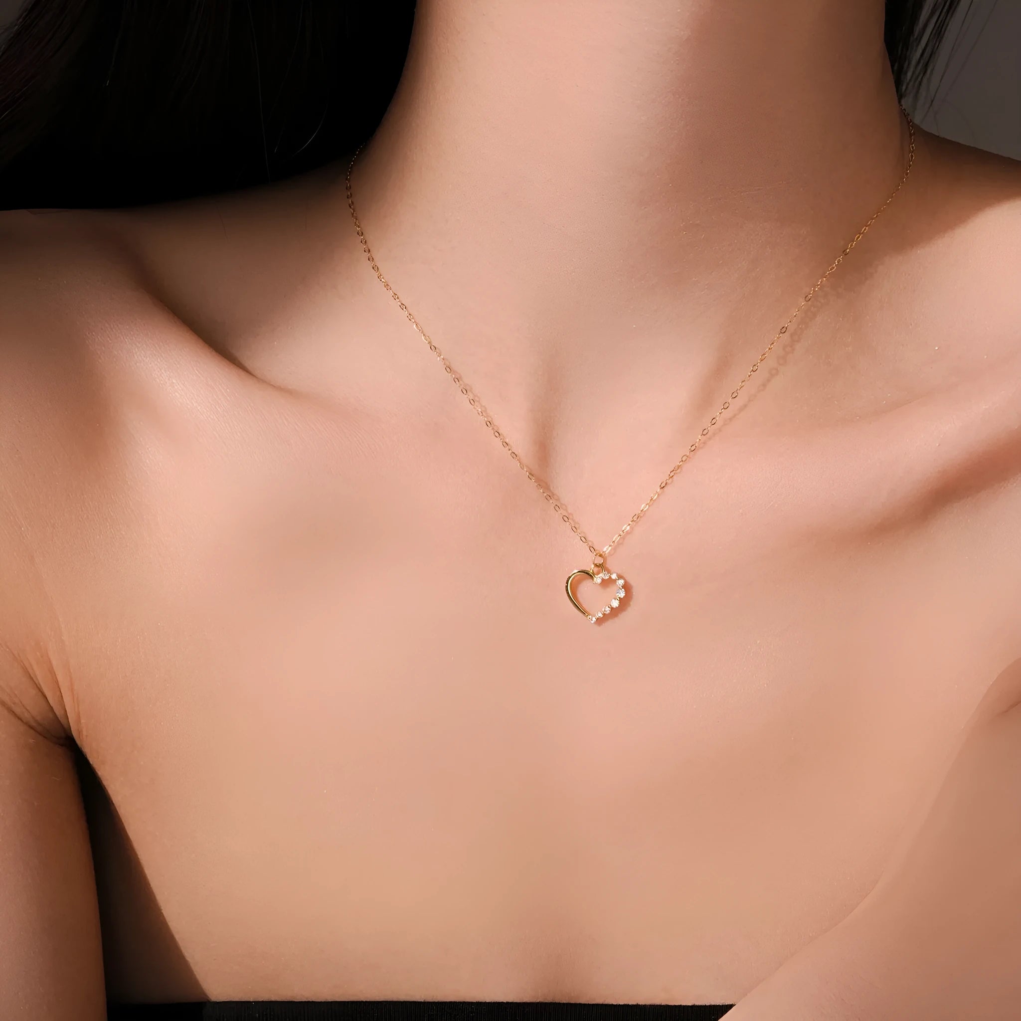 Sterling silver hollow heart and circle pendant necklace on a regular chain, shown in a gold tone finish.