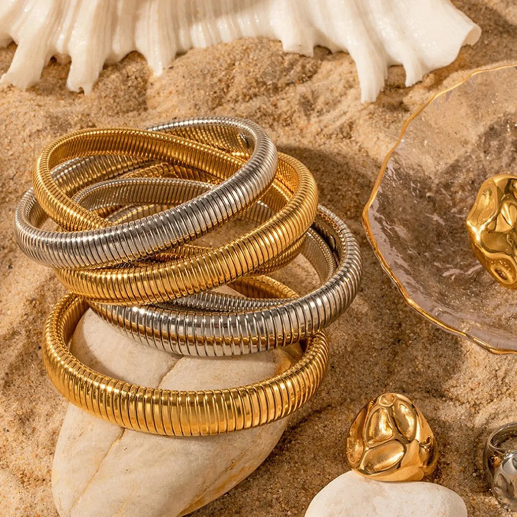 Gold titanium steel bracelet with elastic vertical stripe ring design, shown at 2cm width.