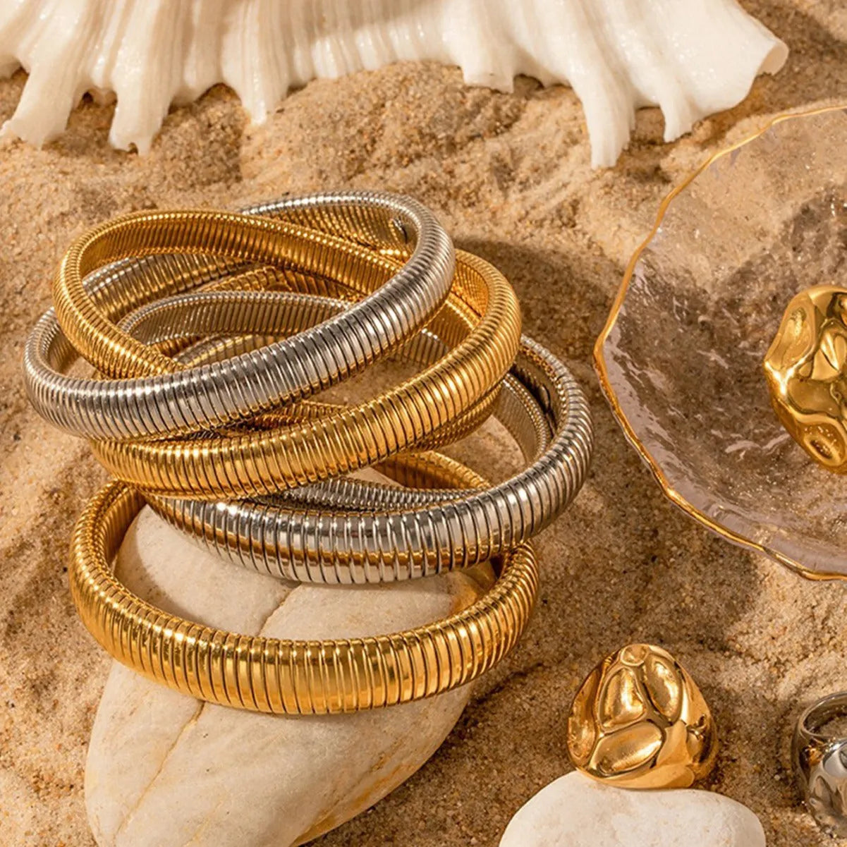 Gold titanium steel bracelet with elastic vertical stripe ring design, shown at 2cm width.