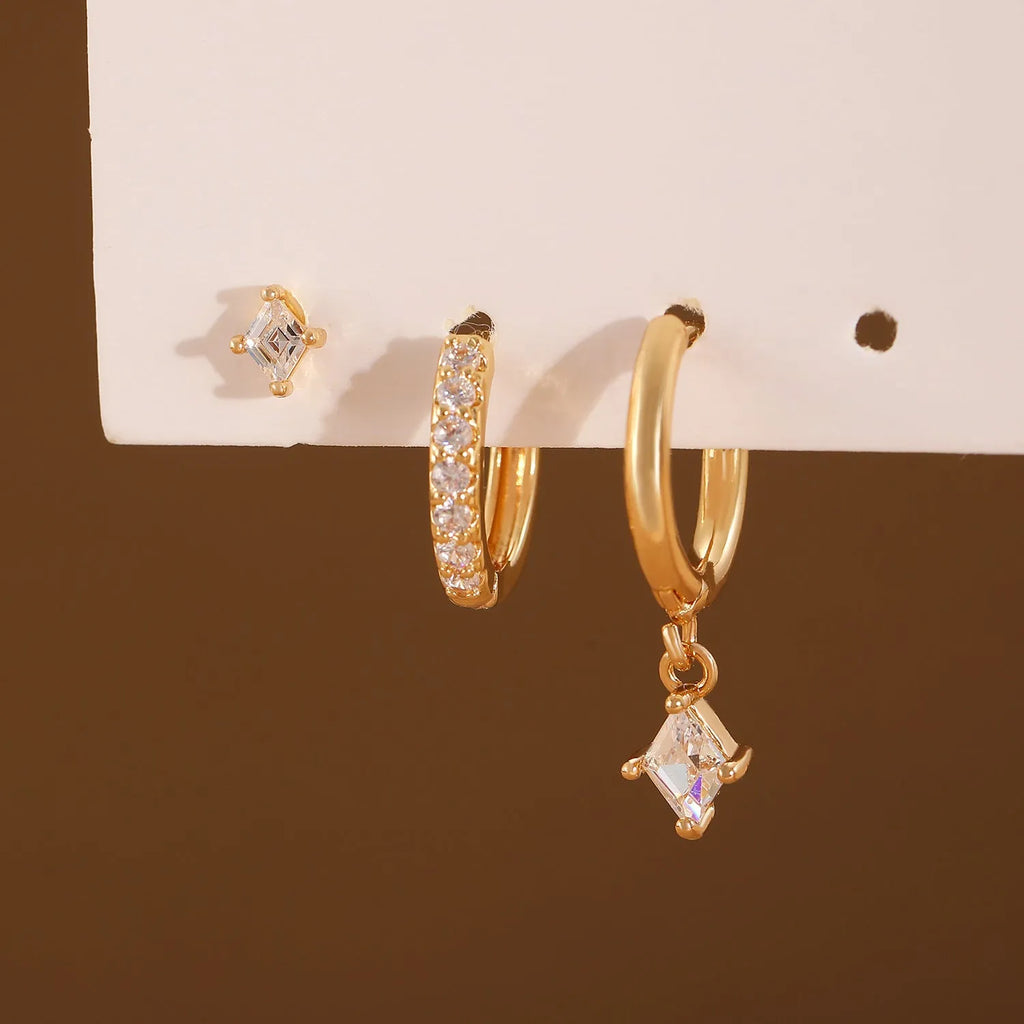 Three-piece geometric earrings set with inlaid zircon detailing on copper in gold and white colours