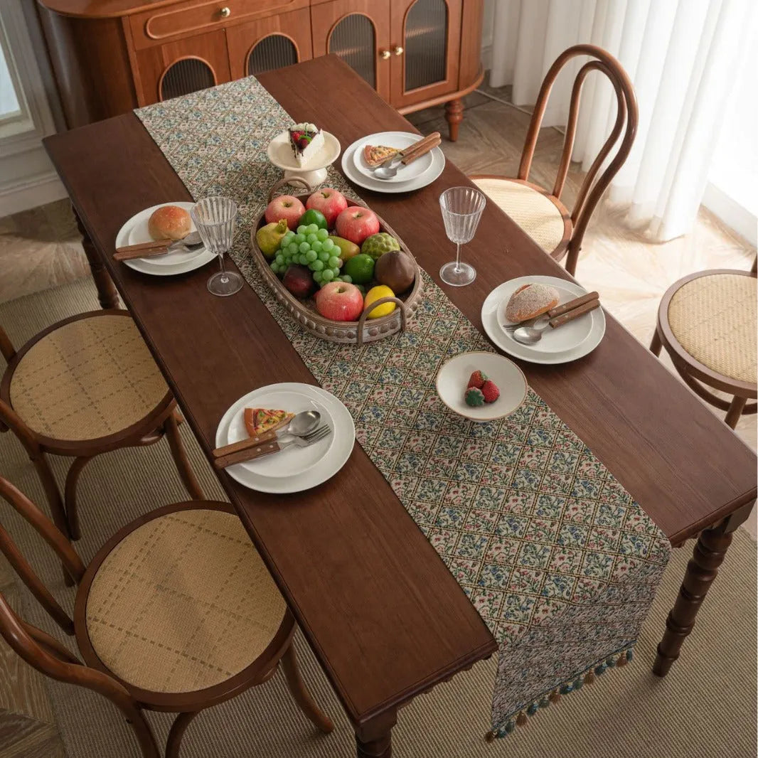 Dark blue Nordic jacquard table runner with bouquet pattern and tassel fringe on wooden table