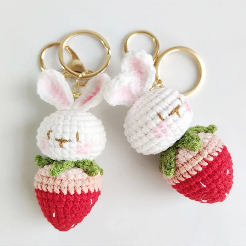 Hand-woven white wire pendant with rabbit and strawberry cartoon design and attached key