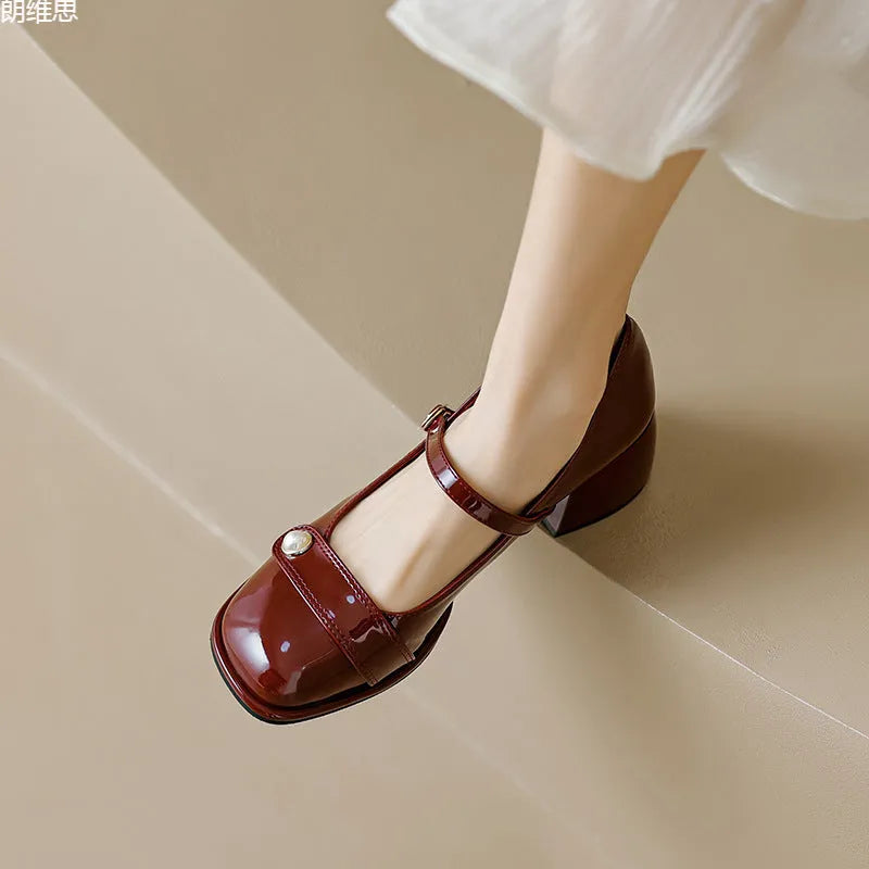 Plus size women's chunky heel pumps in patent leather with a square toe and front buckle, shown in apricot colour.