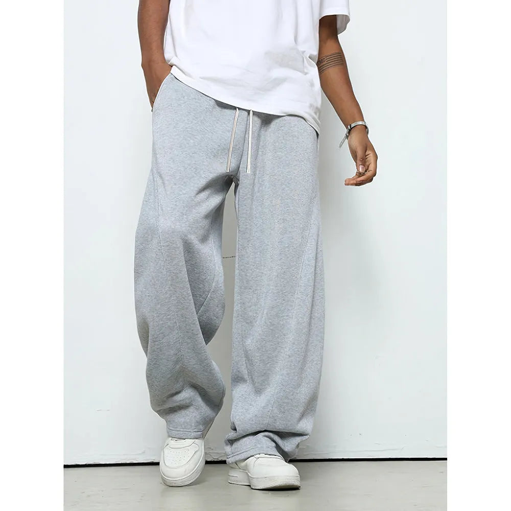 Men's straight leg casual trousers in black with a drawstring waist, laid flat.
