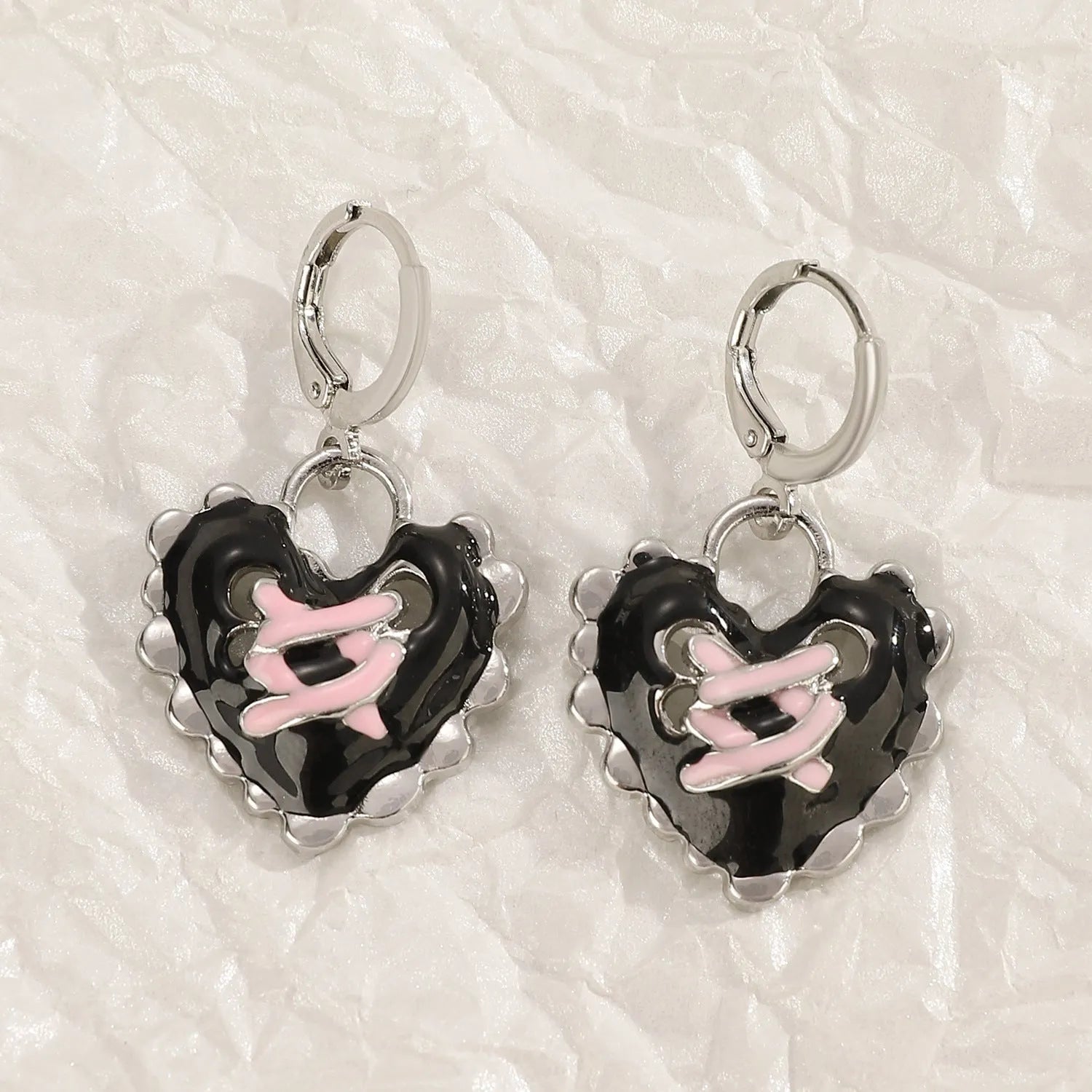 Women's alloy drop earrings featuring cross, heart, and cat charms in white, black, and antique silver finishes.