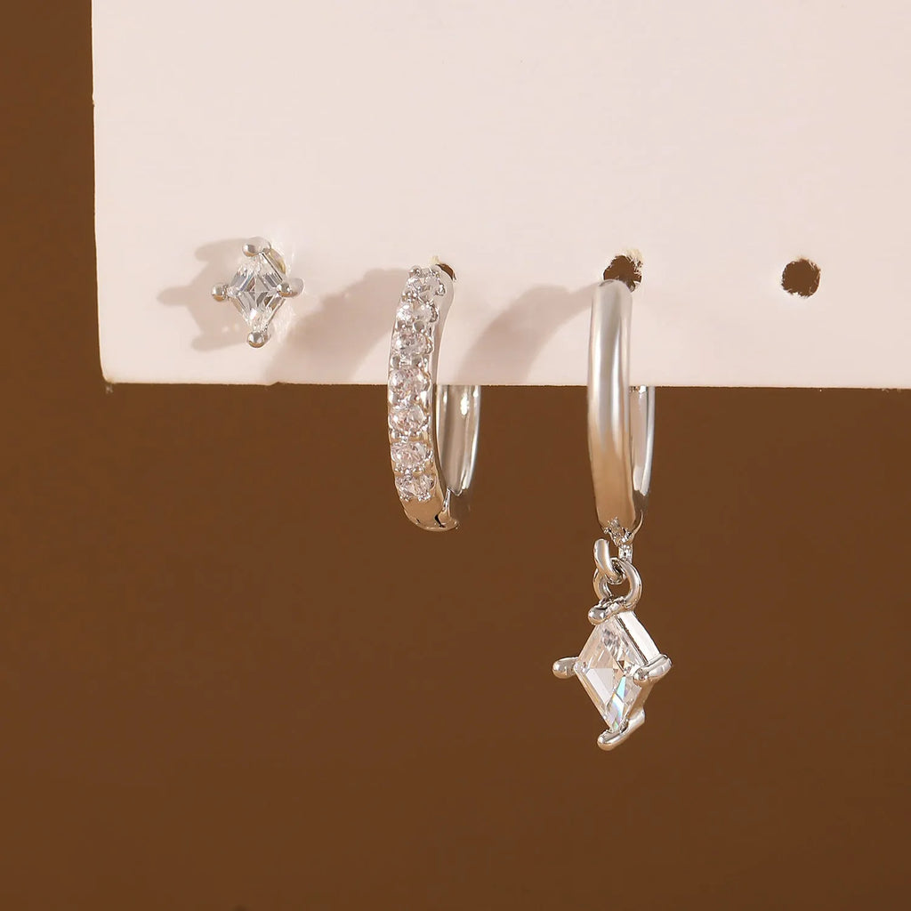 Three-piece geometric earrings set with inlaid zircon detailing on copper in gold and white colours