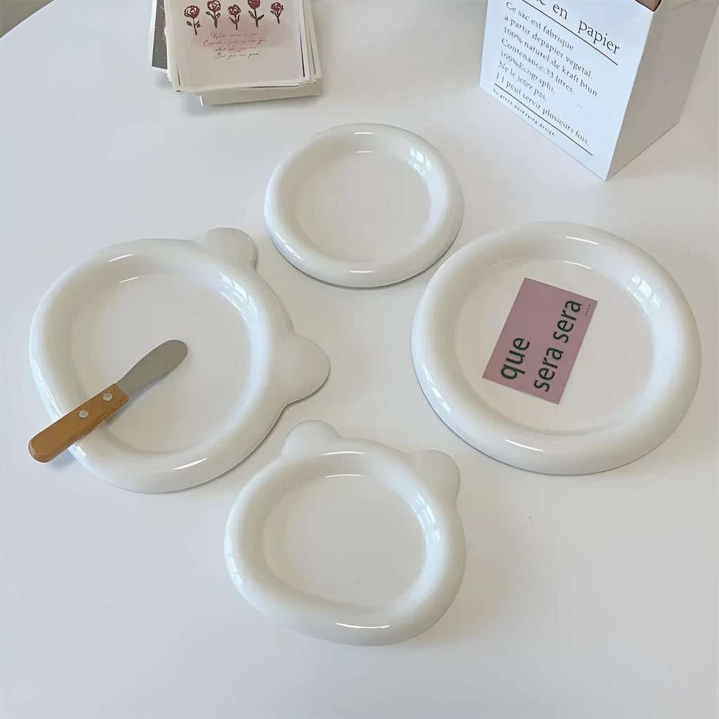 White ceramic plate with doodle design showing bear pattern, suitable for microwave use