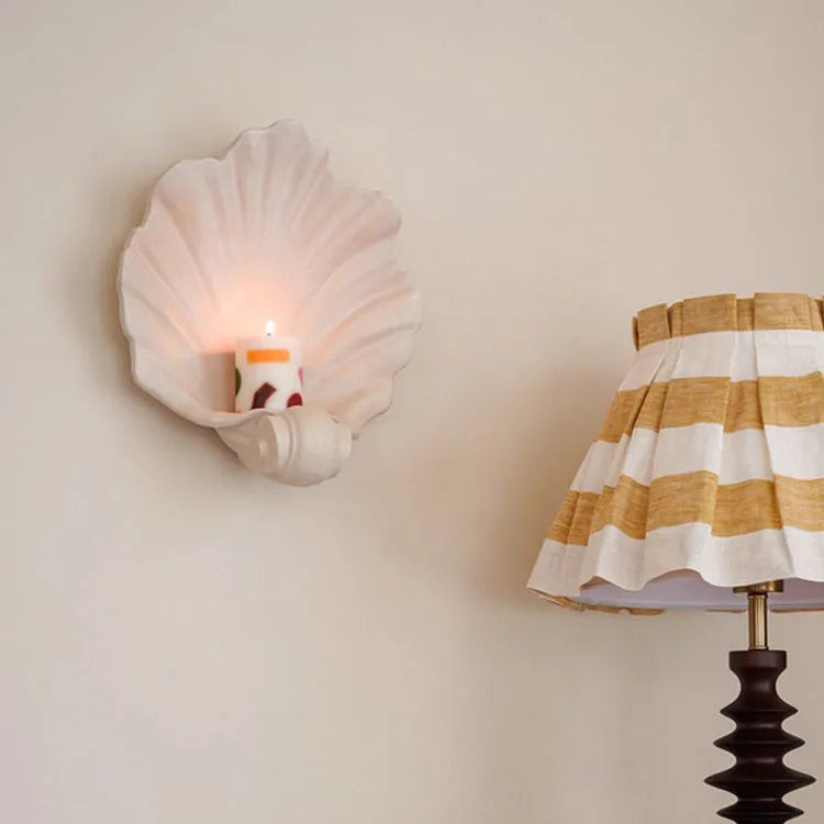 White resin shell-shaped fruit plate ornament on table setting