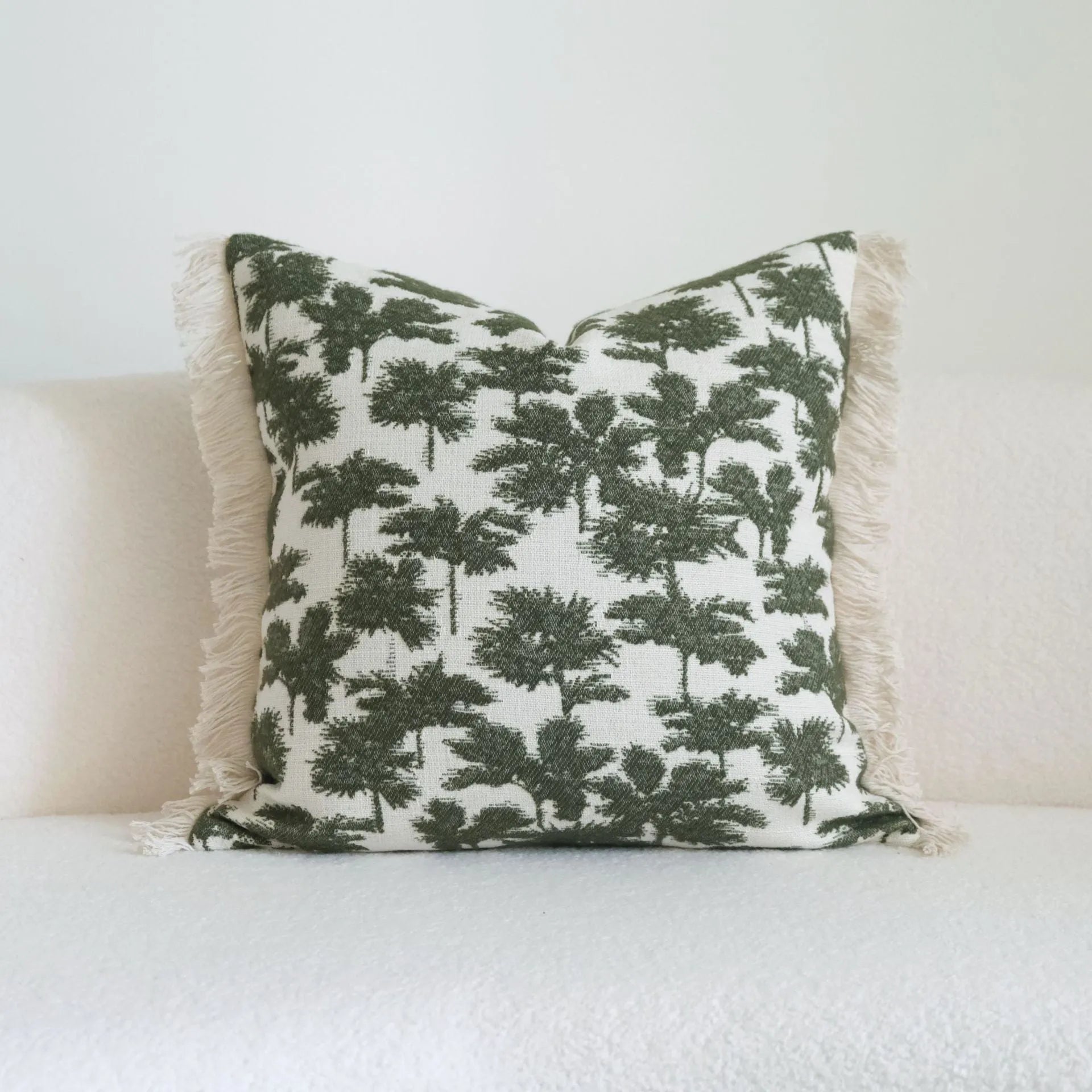 Green cotton and linen tassel hotel sample pillow with botanical patterns on a brushed fabric case