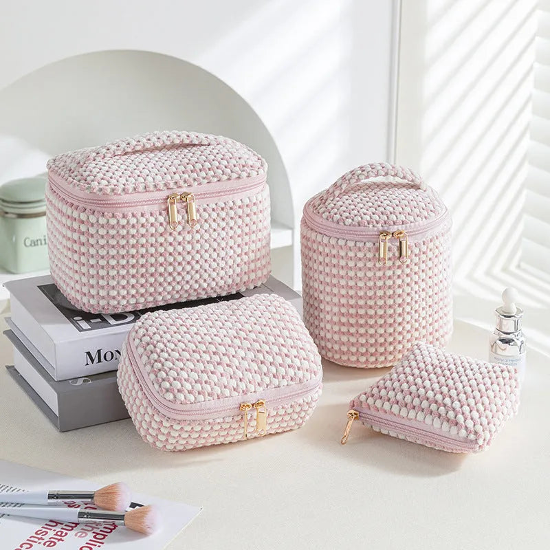 Four cube-style polyester makeup bags in coordinating colours