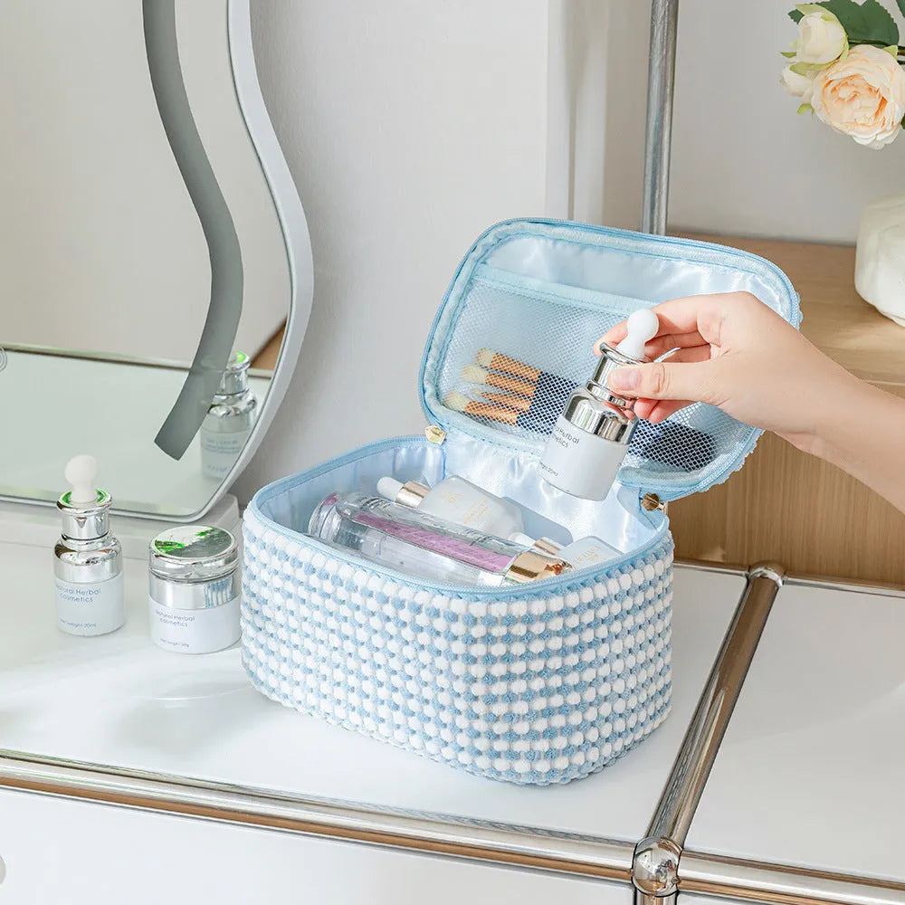 Four cube-style polyester makeup bags in coordinating colours