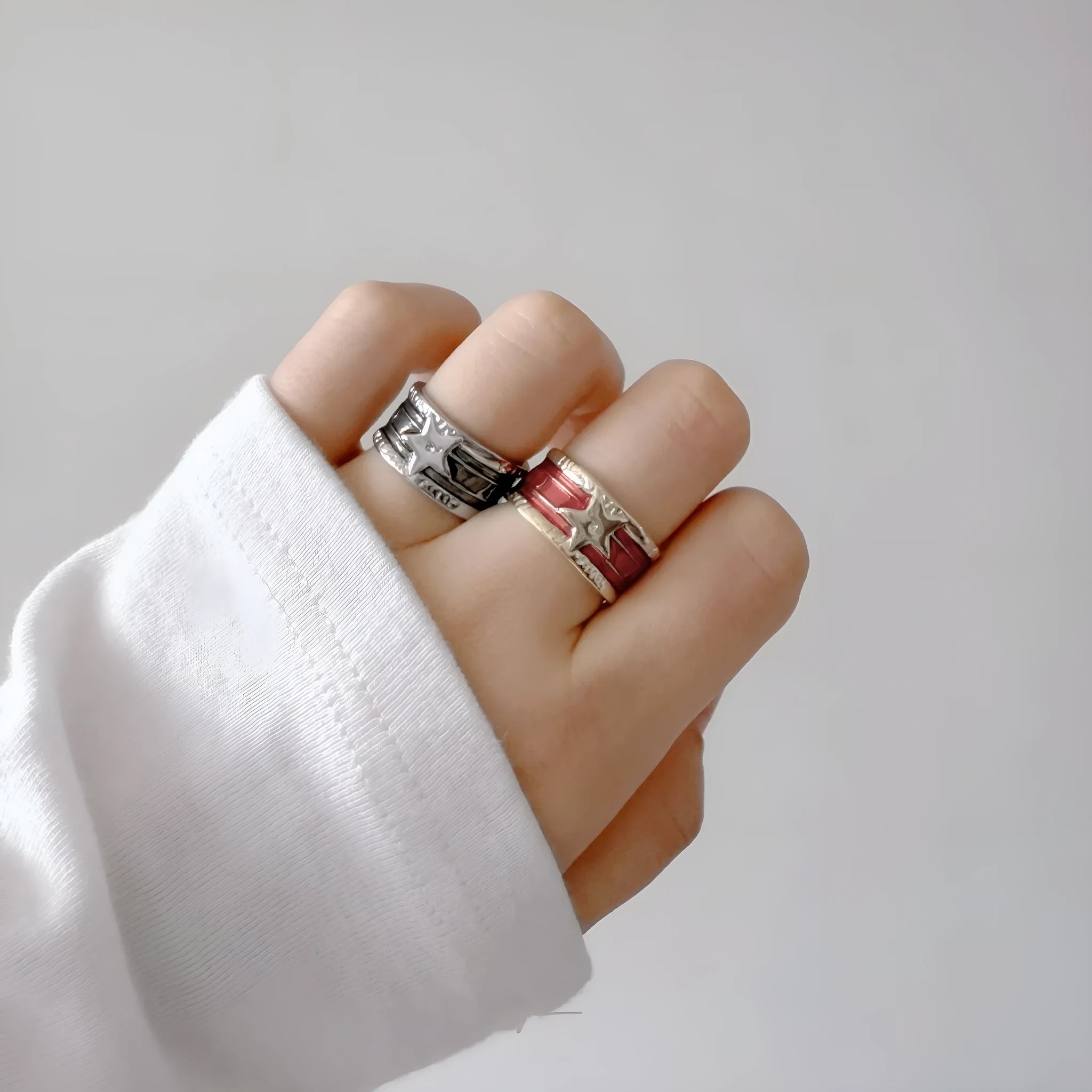 Adjustable copper drop oil ring with a distressed XINGX design in geometric shape.