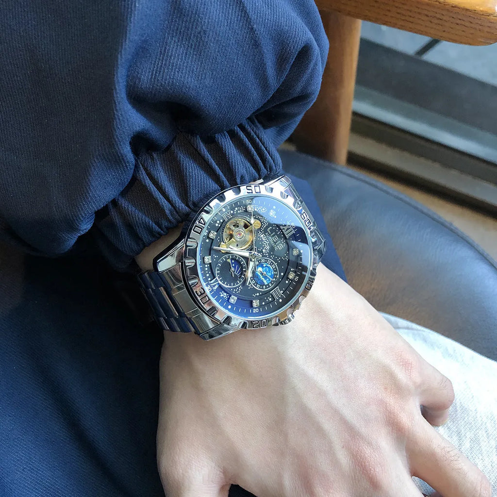 Men's silver automatic mechanical watch with starry dial, luminous hands, and black leather strap.