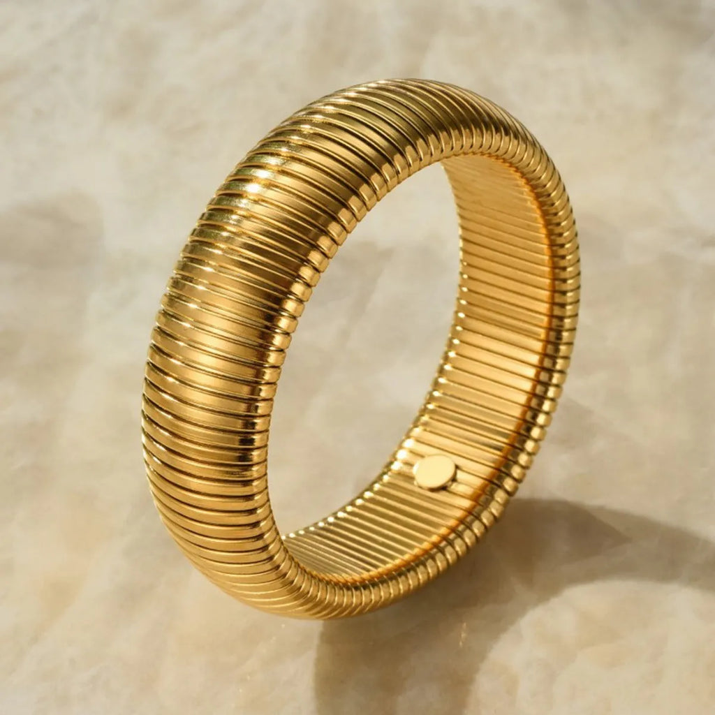 Gold titanium steel bracelet with elastic vertical stripe ring design, shown at 2cm width.