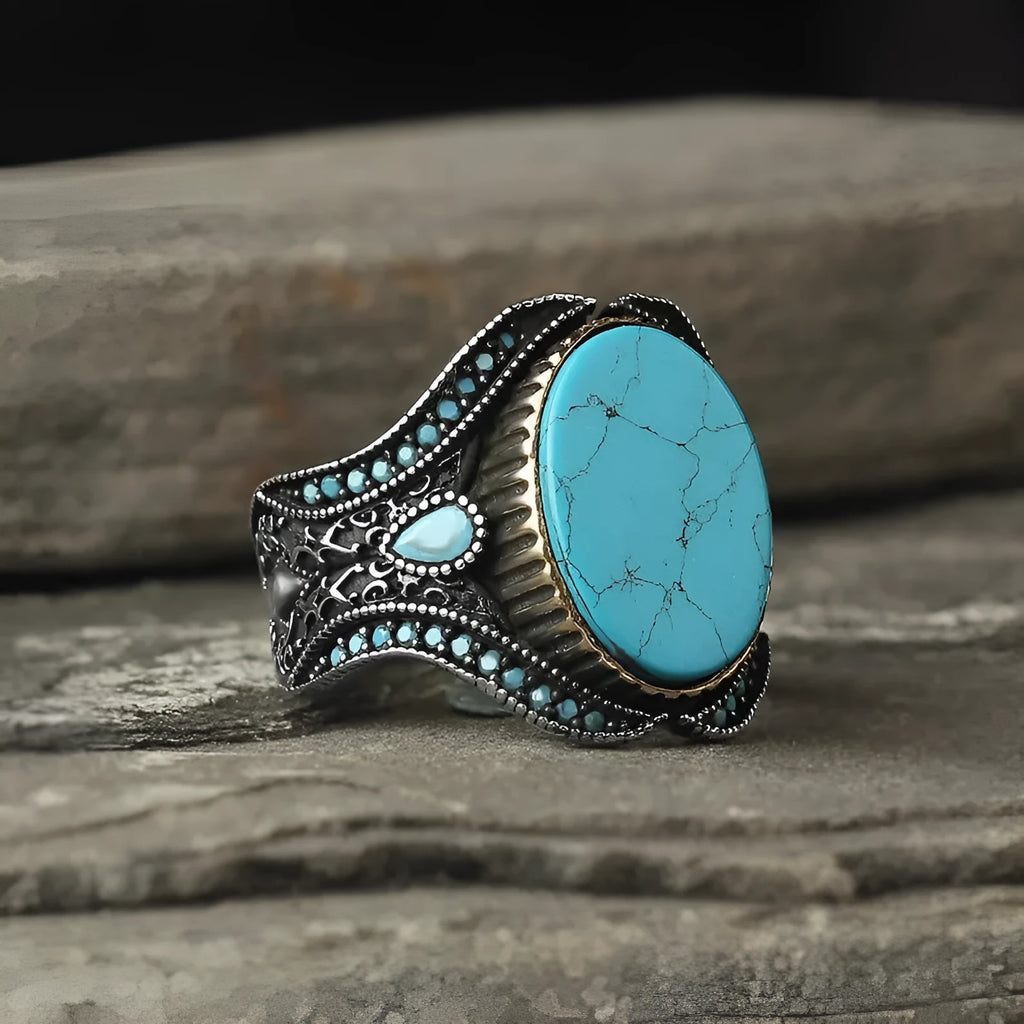 Men's antique silver alloy ring with turquoise accent on finger, showing round shape and simple design