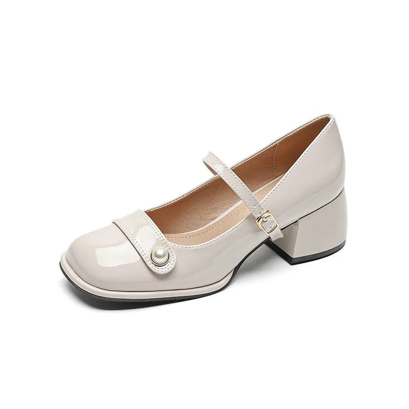 Plus size women's chunky heel pumps in patent leather with a square toe and front buckle, shown in apricot colour.