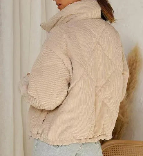 Apricot coloured women's corduroy jacket with stand collar and front zip, showing textured fabric detail
