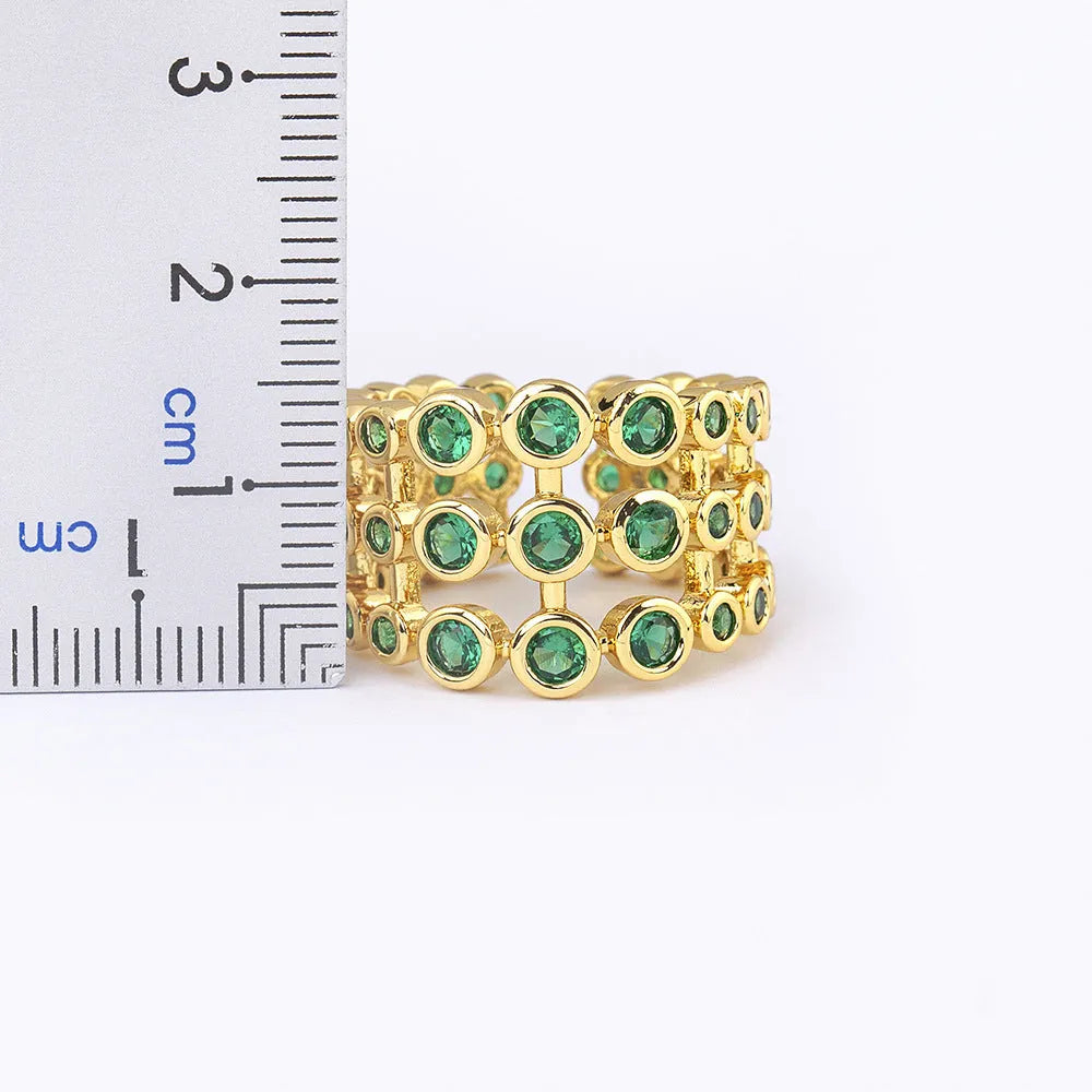 Gold coloured wide band ring with green zircon stones and three-layer copper plating