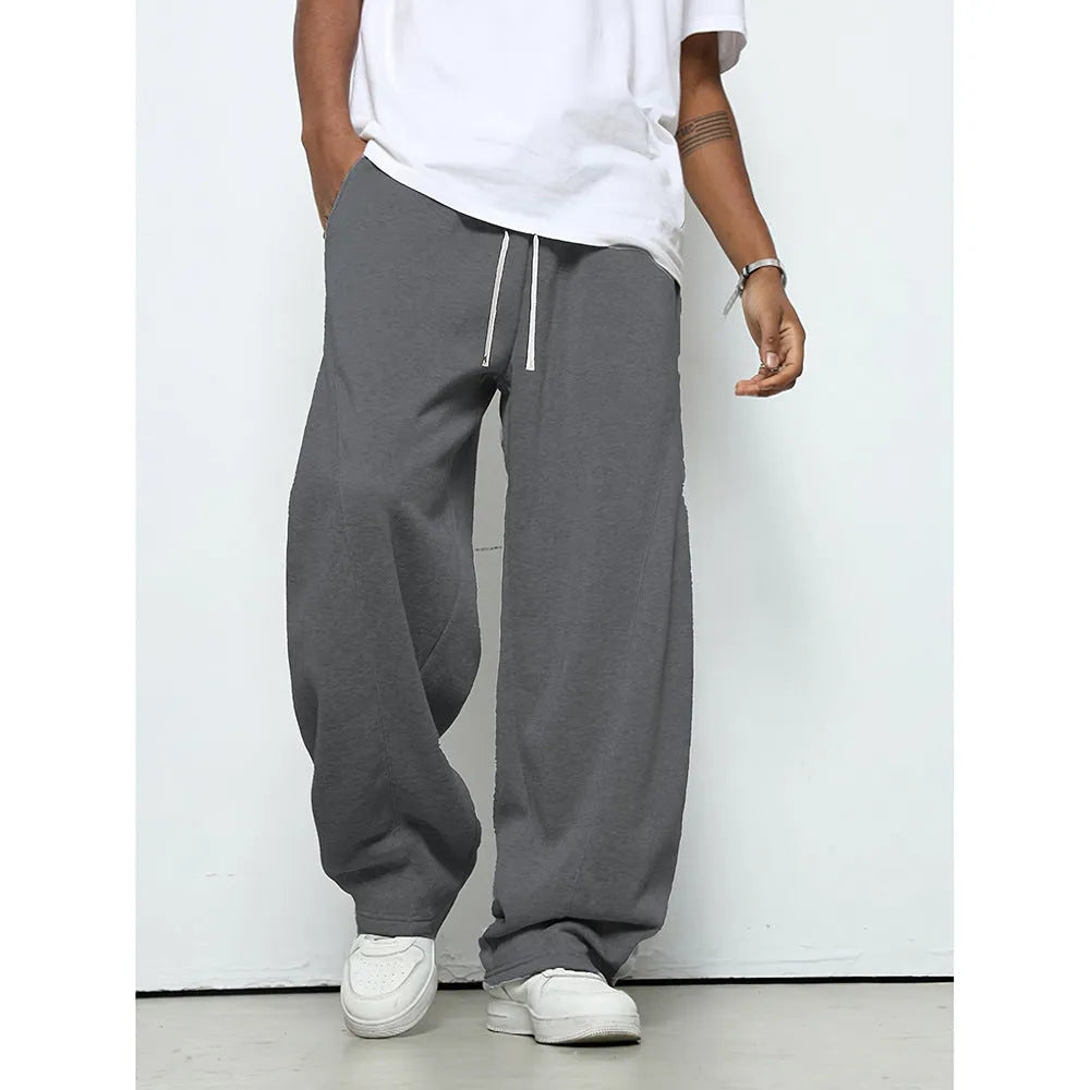 Men's straight leg casual trousers in black with a drawstring waist, laid flat.