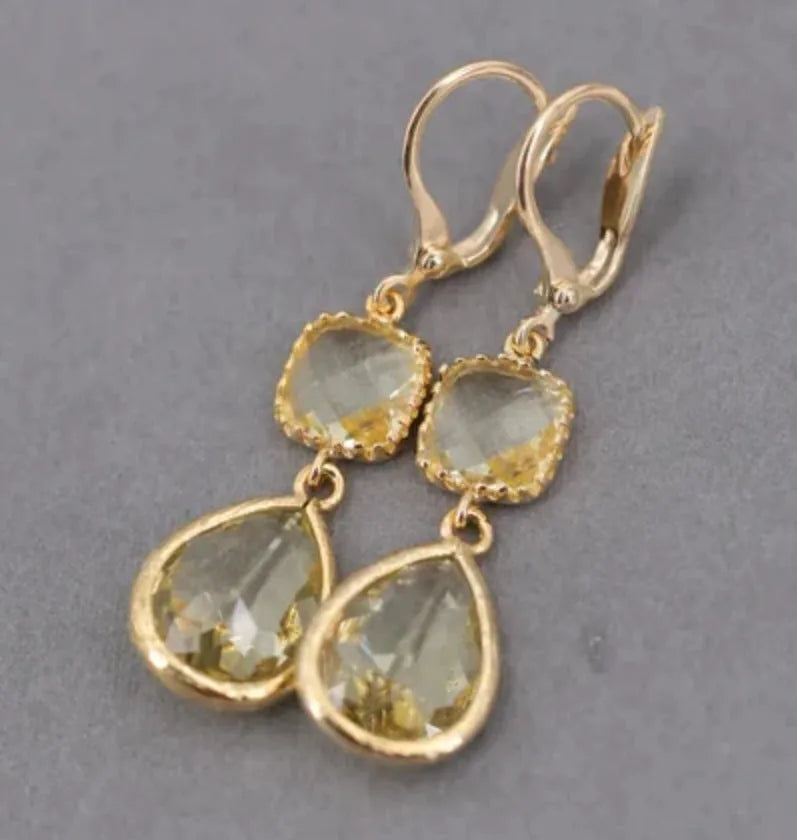 Gold retro geometric earrings with long crystal fringe and water droplet design.