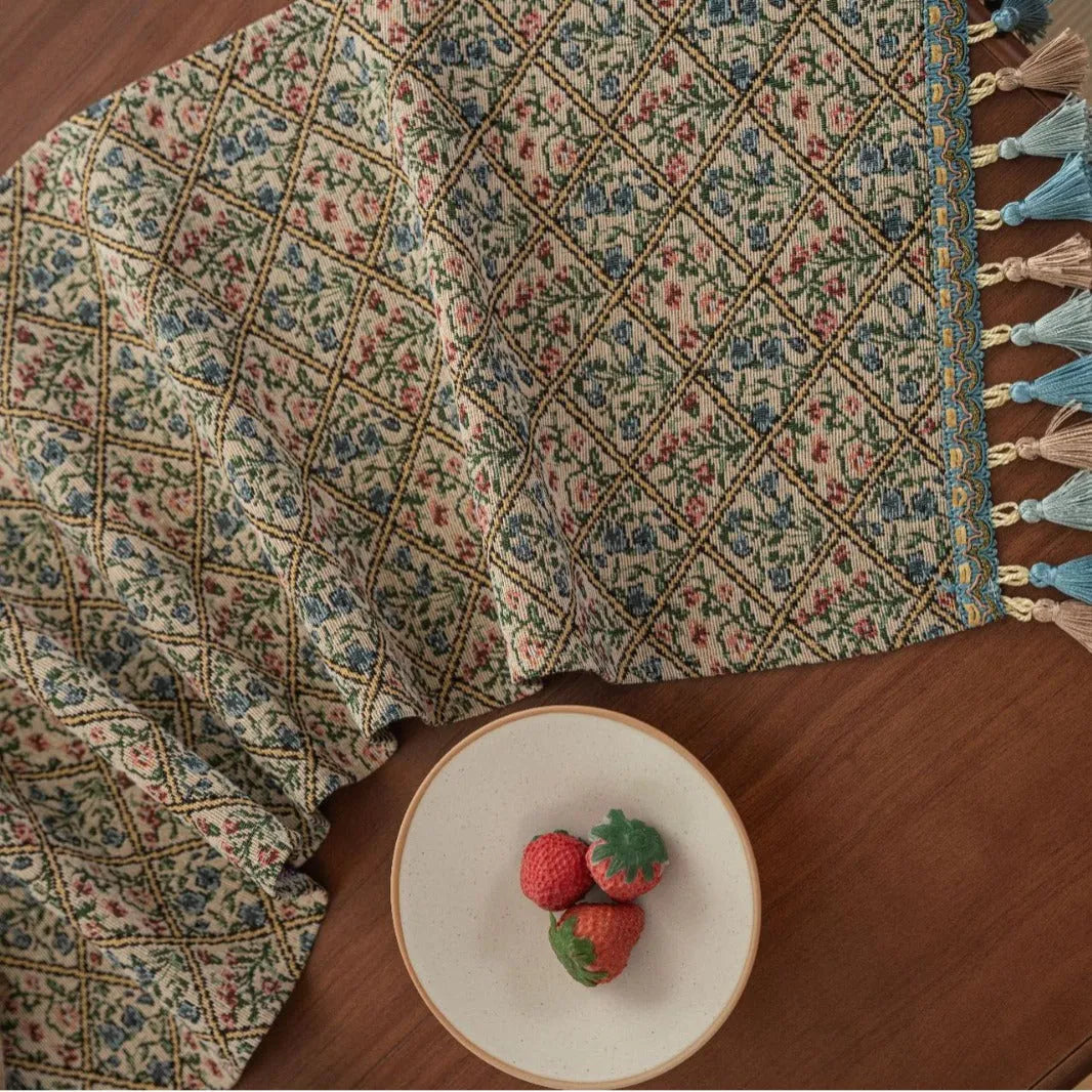 Dark blue Nordic jacquard table runner with bouquet pattern and tassel fringe on wooden table