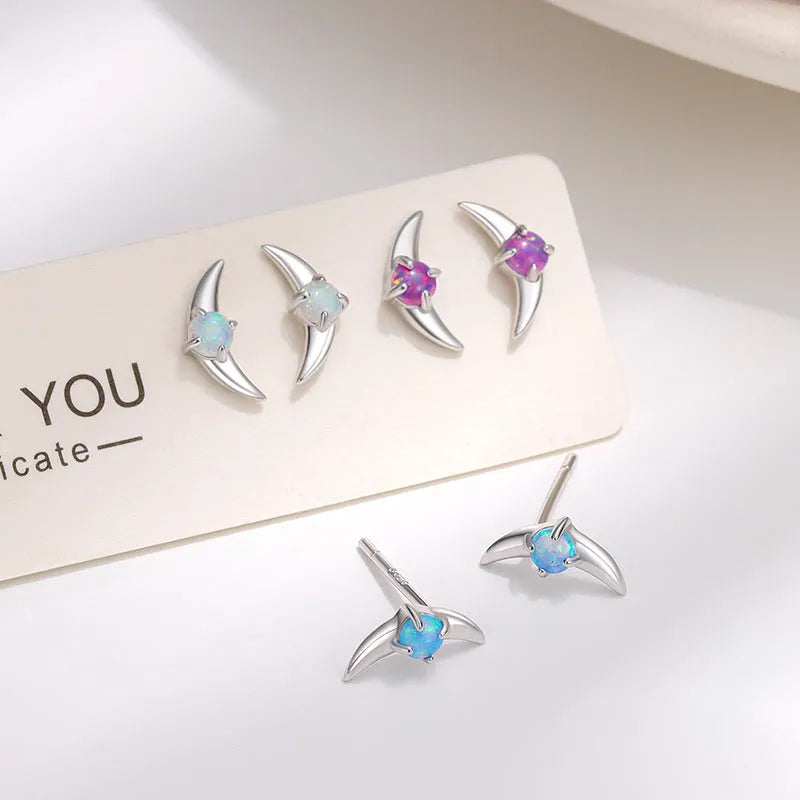 A pair of women's geometric earrings in 925 silver with a blue stone and gold electroplated finish.