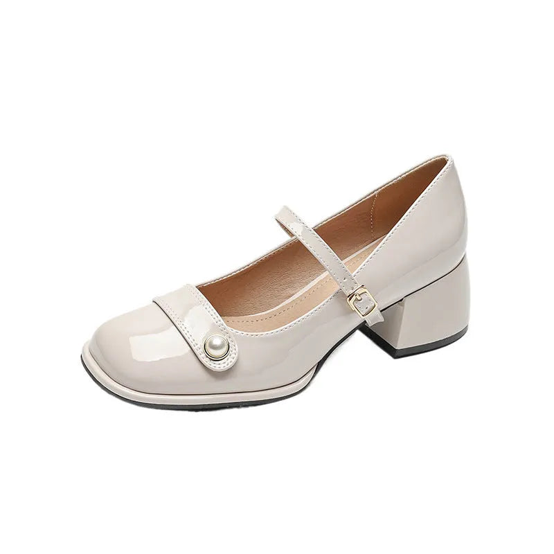 Plus size women's chunky heel pumps in patent leather with a square toe and front buckle, shown in apricot colour.
