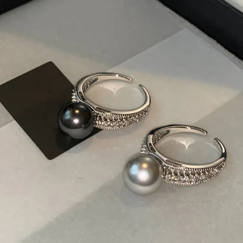 Adjustable black pearl copper ring with geometric open design for women