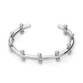 Stainless steel C-shaped bean bead bracelet with textured rivet finish on an alloy chain.