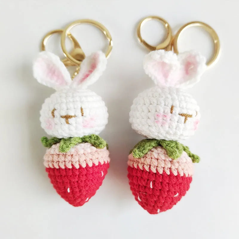 Hand-woven white wire pendant with rabbit and strawberry cartoon design and attached key