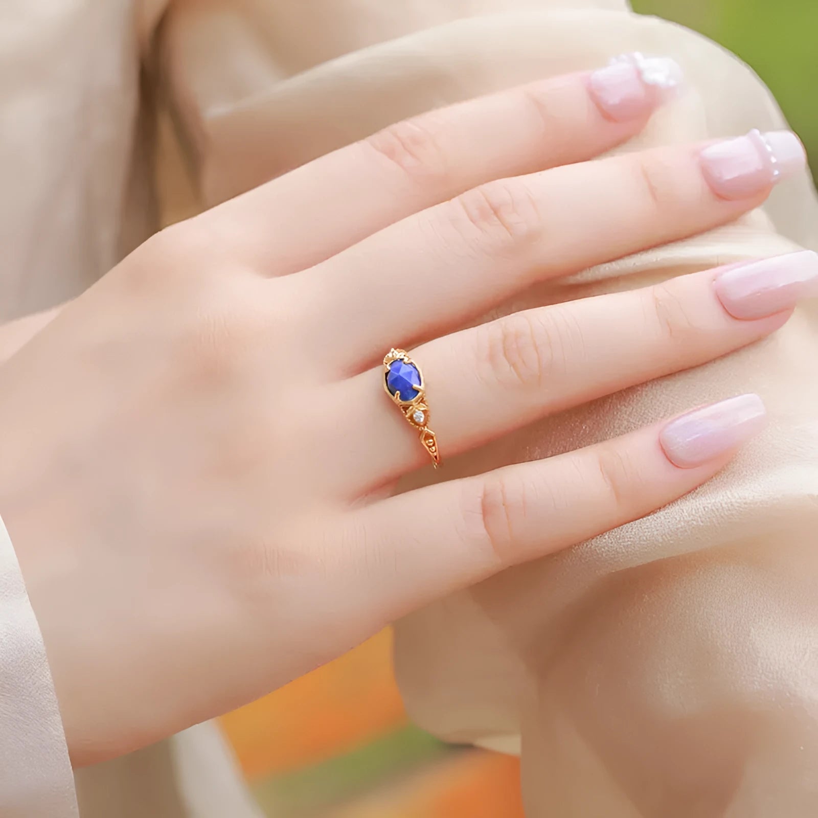 Women's ellipse geometric ring with round blue Lapis Lazuli stone on silver alloy band.