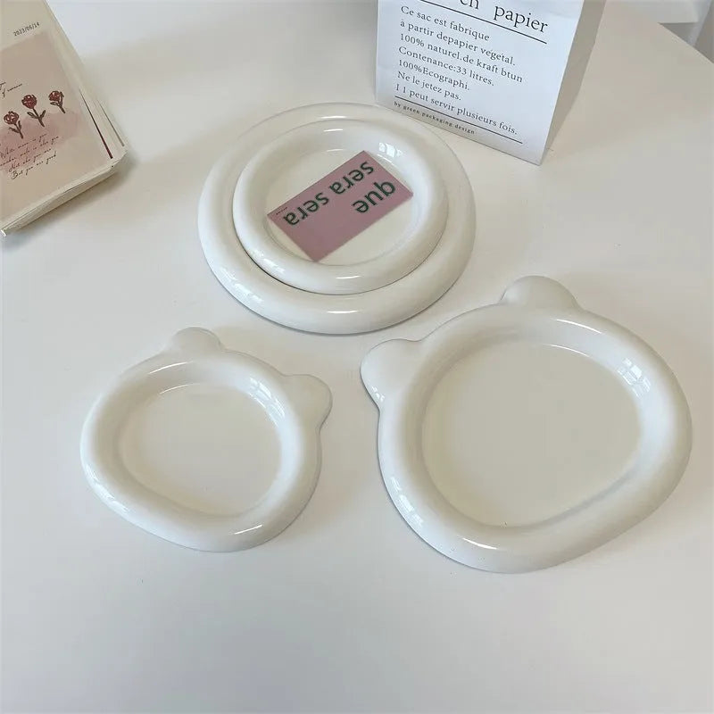 White ceramic plate with doodle design showing bear pattern, suitable for microwave use