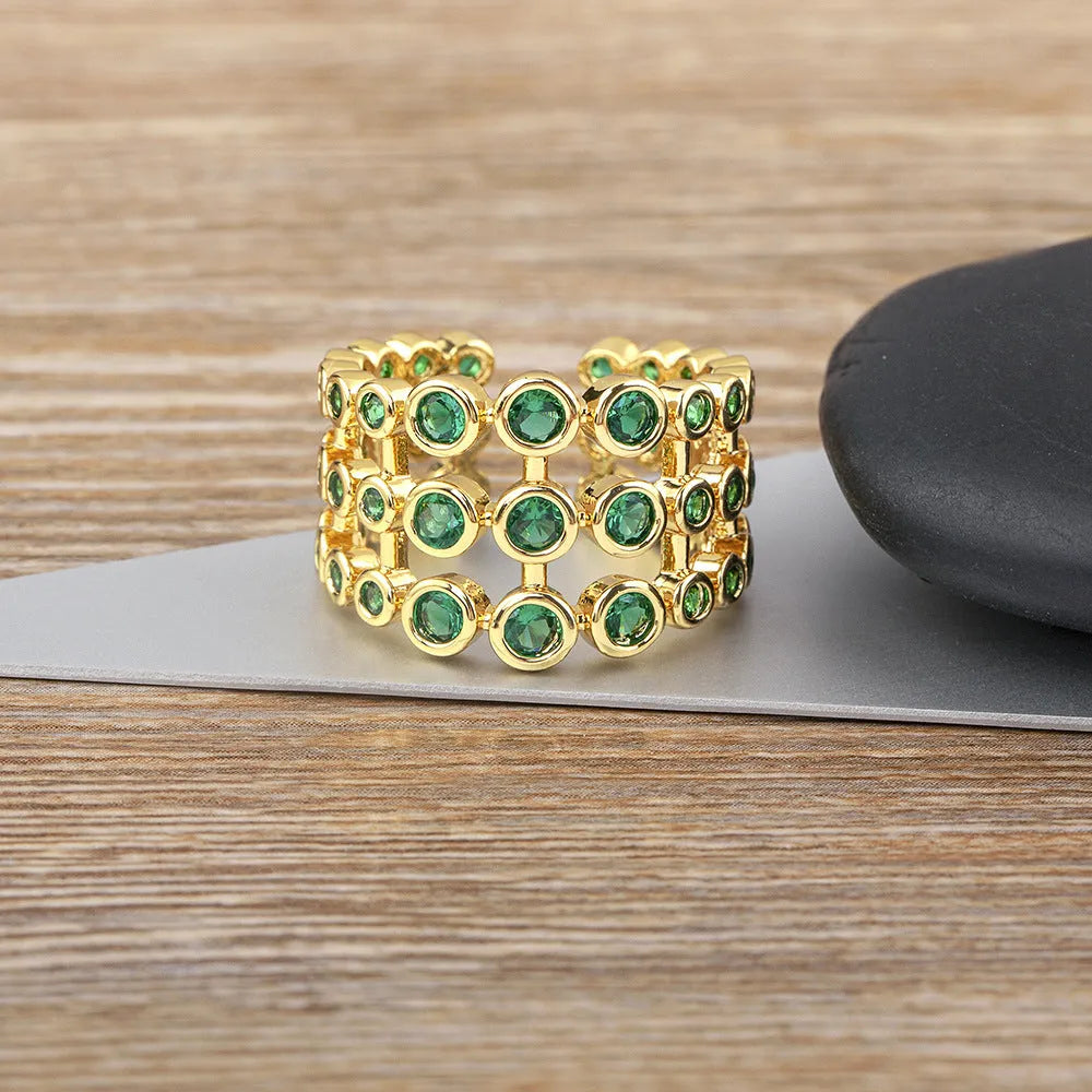Gold coloured wide band ring with green zircon stones and three-layer copper plating