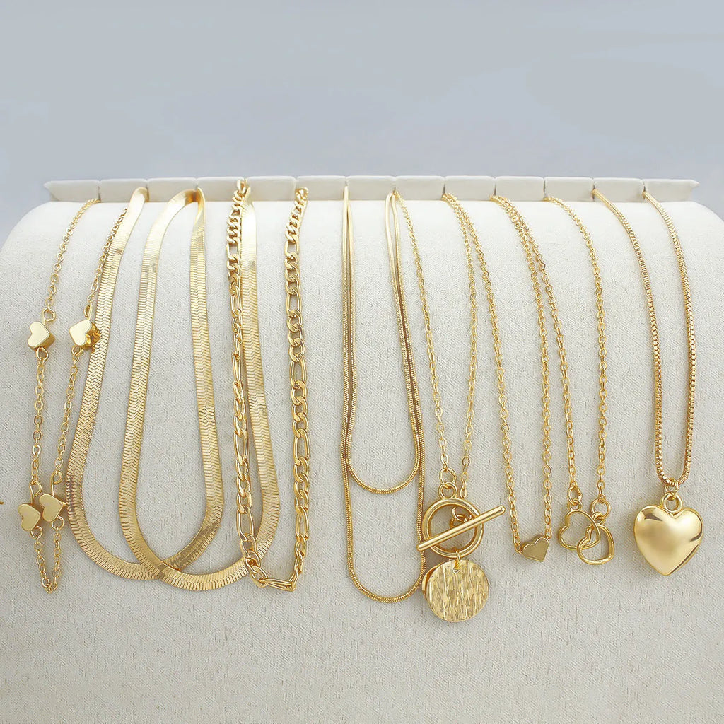10-piece gold electroplated women's necklace set with alloy pendants on adjustable snake bone chain