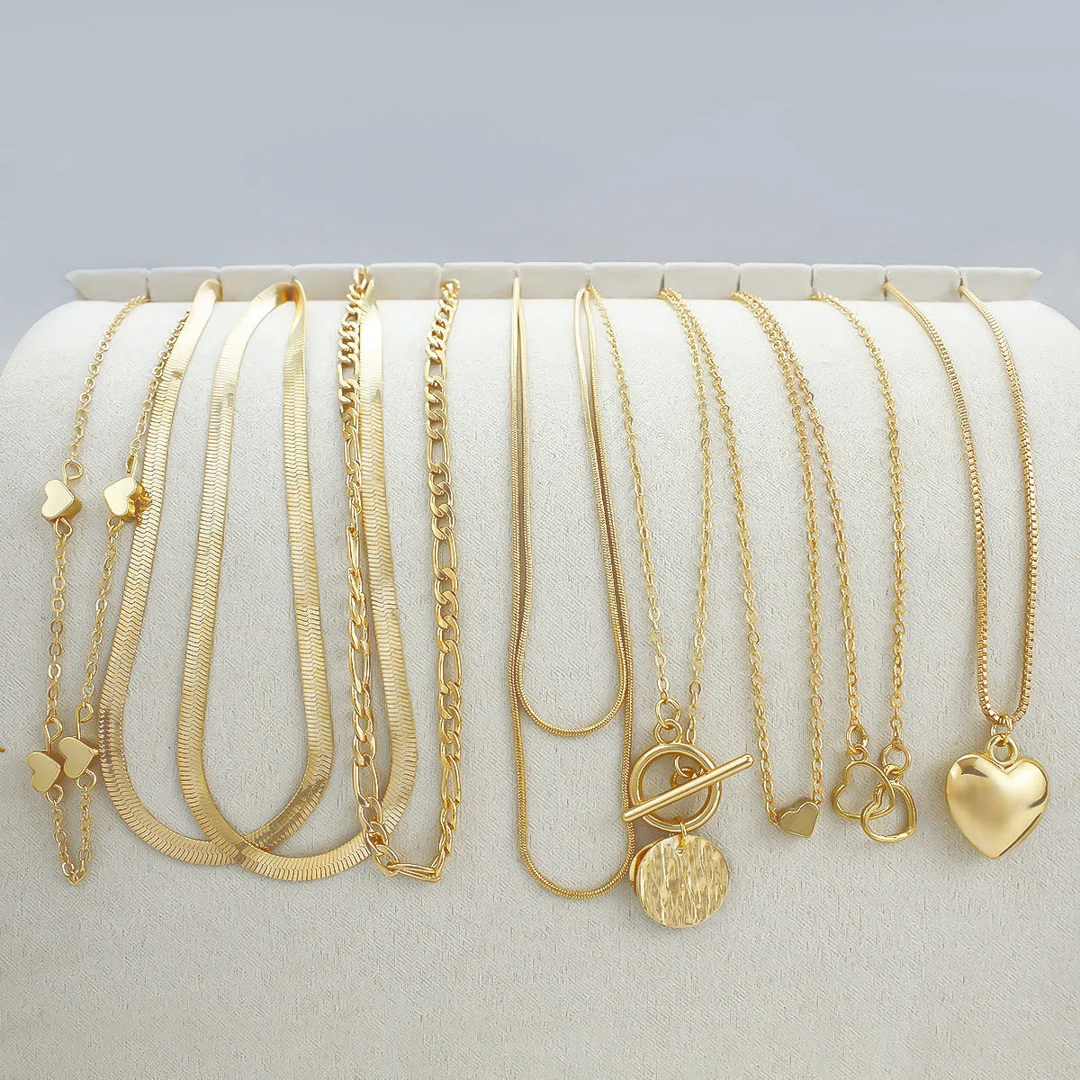 10-piece gold electroplated women's necklace set with alloy pendants on adjustable snake bone chain