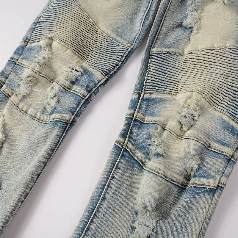 Light blue men's slim fit distressed jeans with hand-frayed details and a straight leg opening.
