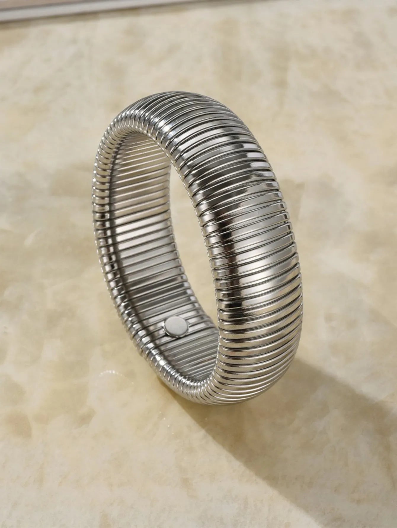 Gold titanium steel bracelet with elastic vertical stripe ring design, shown at 2cm width.
