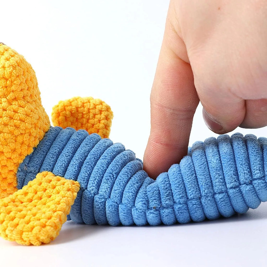 Soft plush squeaky dog chew toy in animal shape for dental care and play.